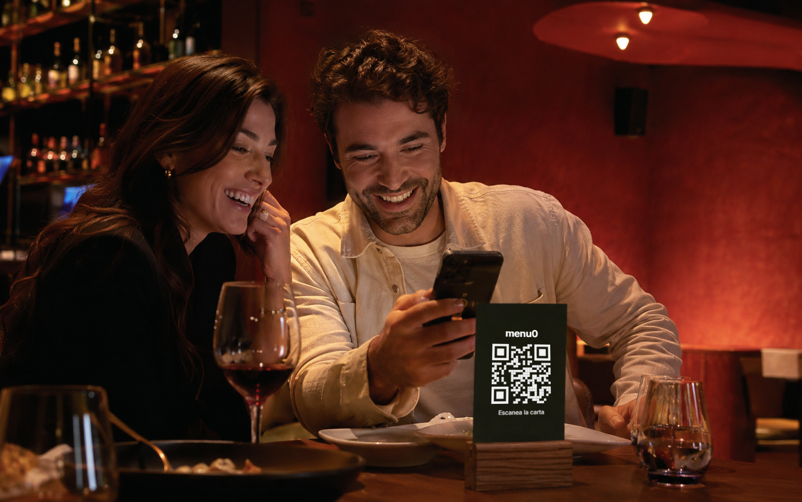 Pareja escaneando el QR de menu0 en la mesa de un restaurante